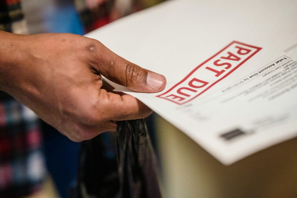 Unopened mail and past due bills in senior parent’s kitchen signaling possible memory decline and home safety concerns