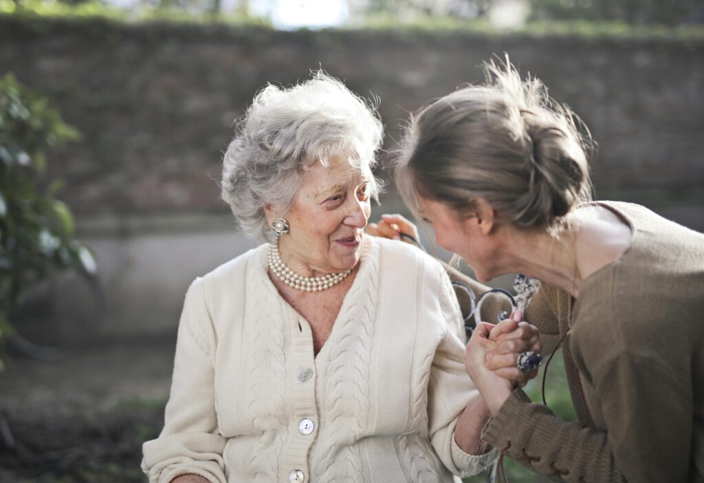 Senior living staff interacting with senior in a senior living community, asking questions
