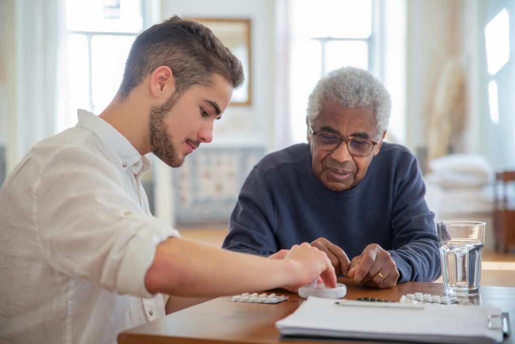 Assisted living caregiver spending time and speaking with a senior resident, showing compassionate care in a senior community